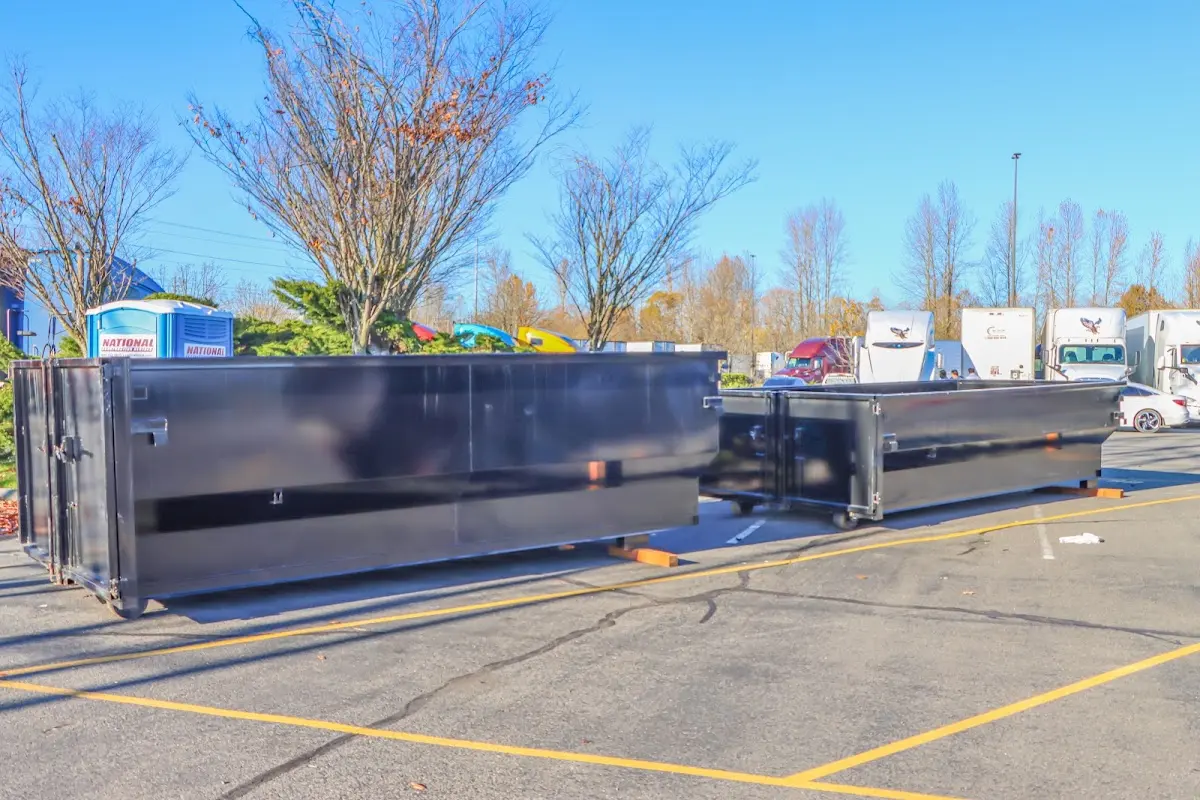 Professional dumpster rental service with roll-off container on residential driveway in Castle Pines Village